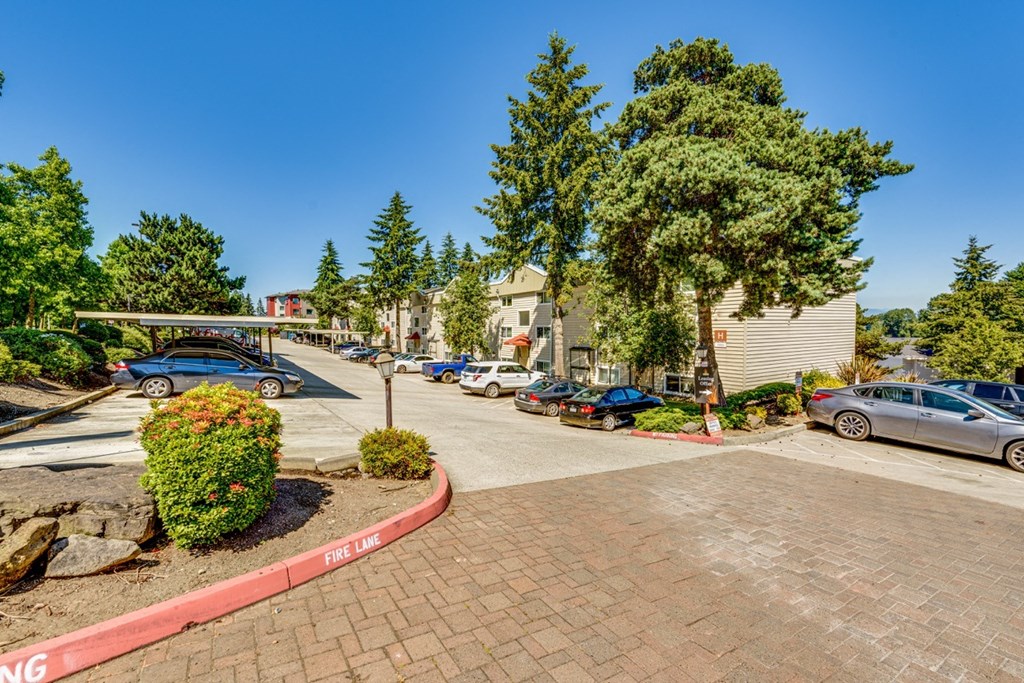 a parking lot with cars parked in front of a building