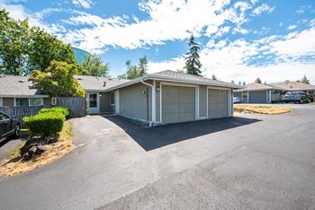 an empty parking lot in front of a house