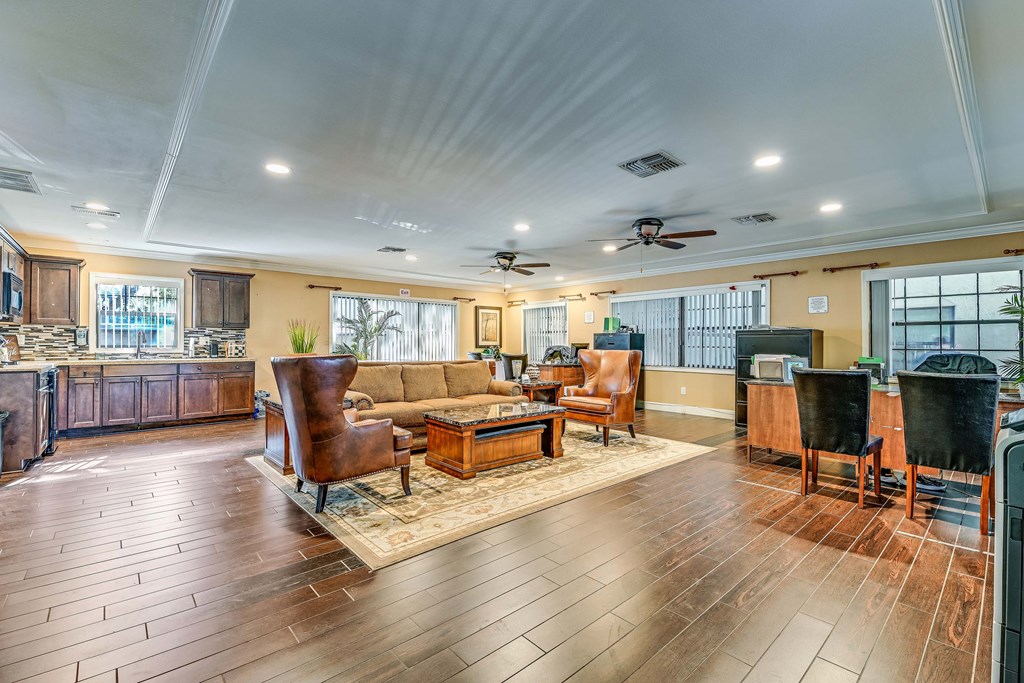 A spacious living room with wooden floors and furniture.