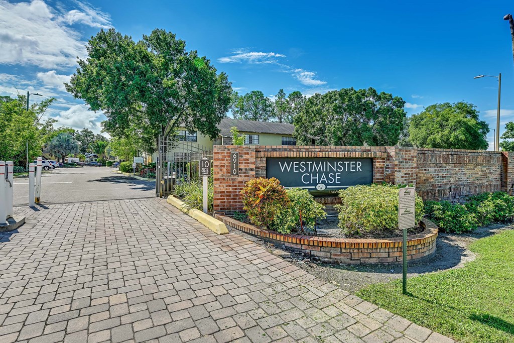 The image shows a brick wall with a sign that reads "Westminster Chase."