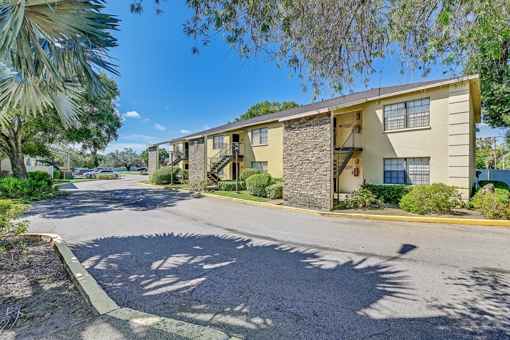 A sunny day at a residential apartment complex with a clear blue sky.