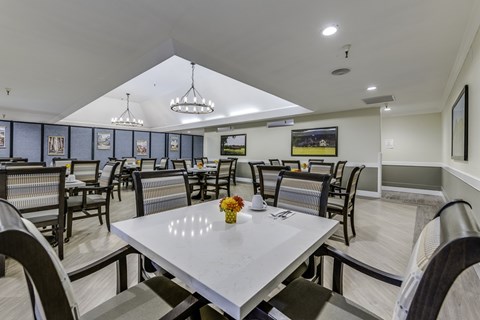 A dining room with a table set for two.