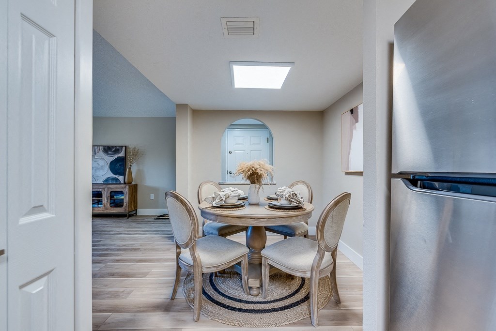 a dining area with a round table and four chairs