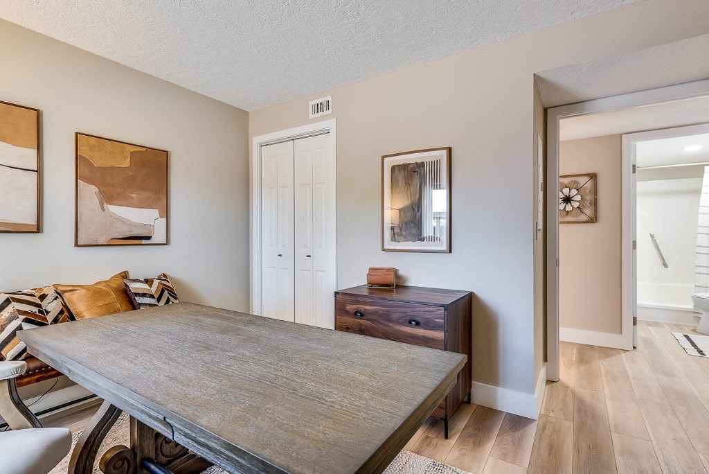 a dining room with a table and chairs