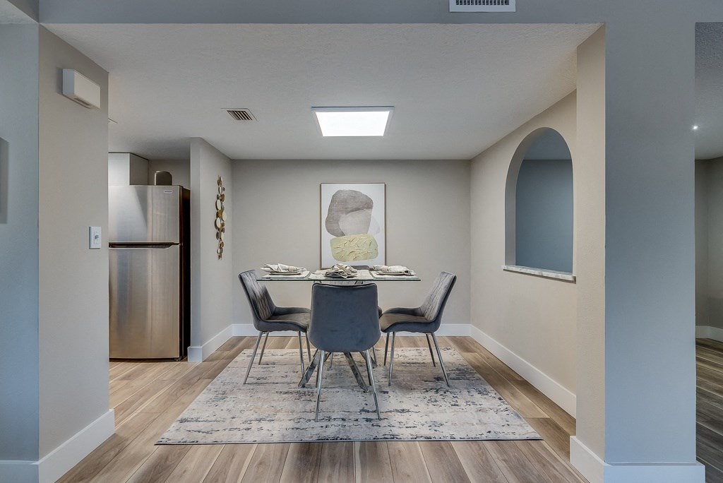 a dining room with a table and chairs