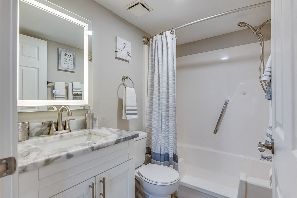 a bathroom with a shower toilet and sink