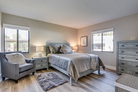 a bedroom with a bed and a chair