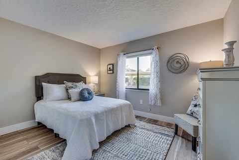 a bedroom with a bed and a dresser