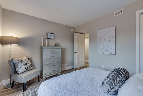 a bedroom with a bed and a dresser