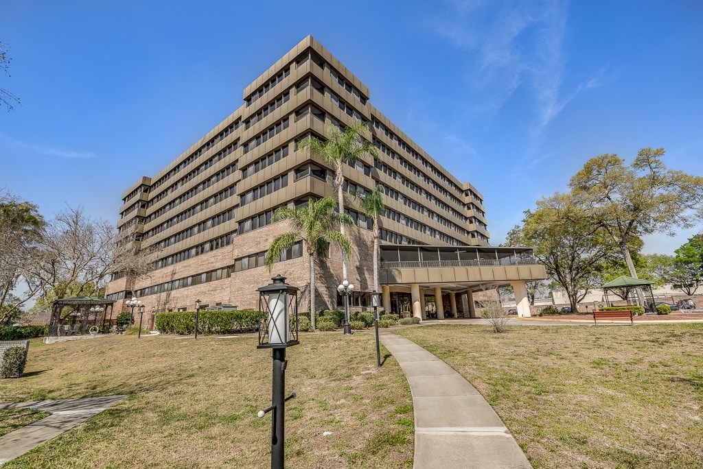 a large building with a grassy area in front of it