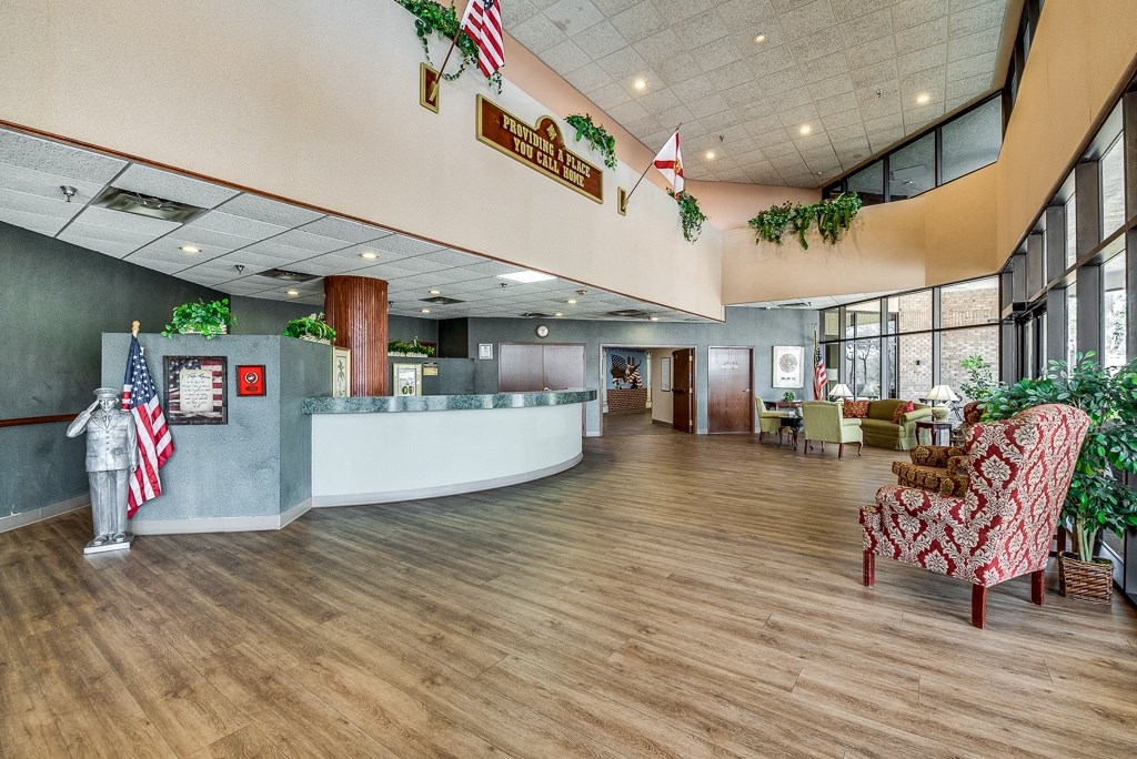 a large lobby with a reception desk and chairs