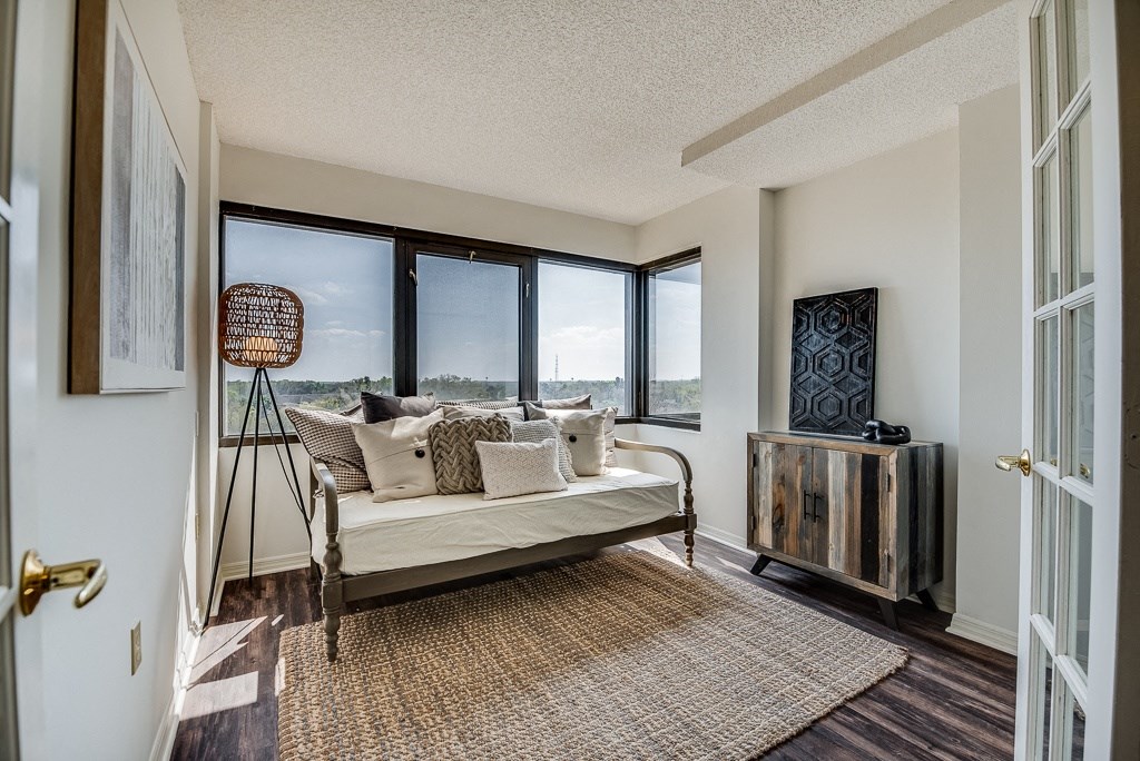 a living room with a couch and large windows