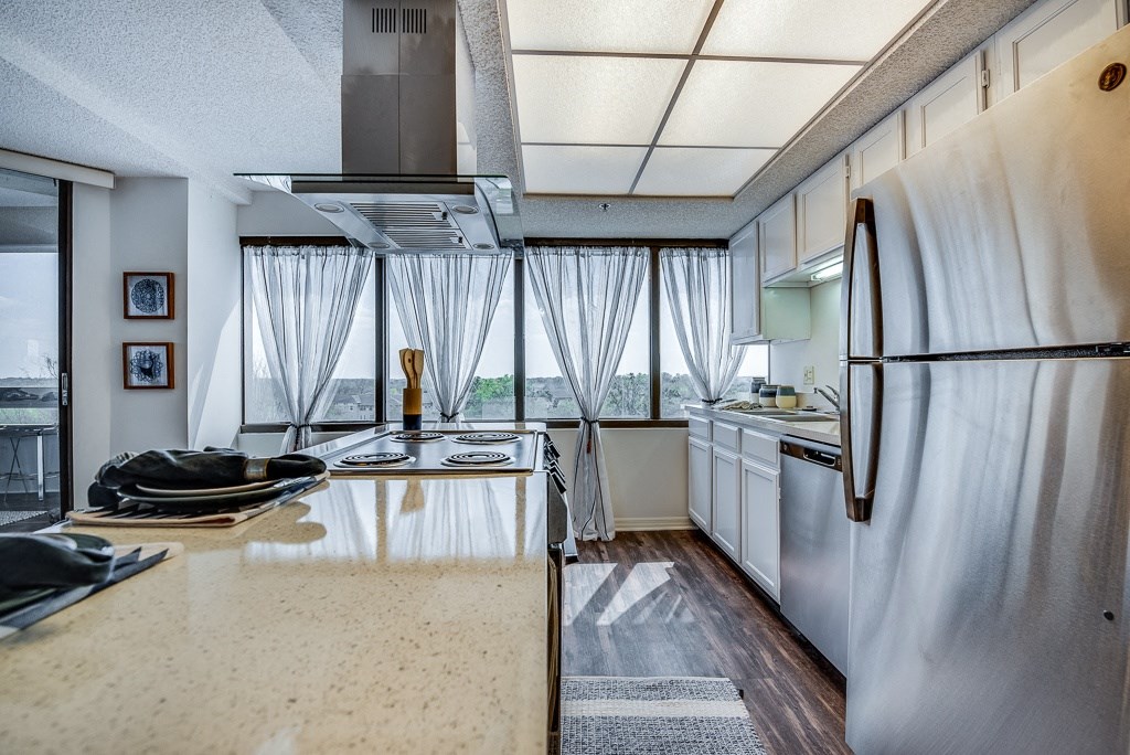 a kitchen with white cabinets and stainless steel appliances