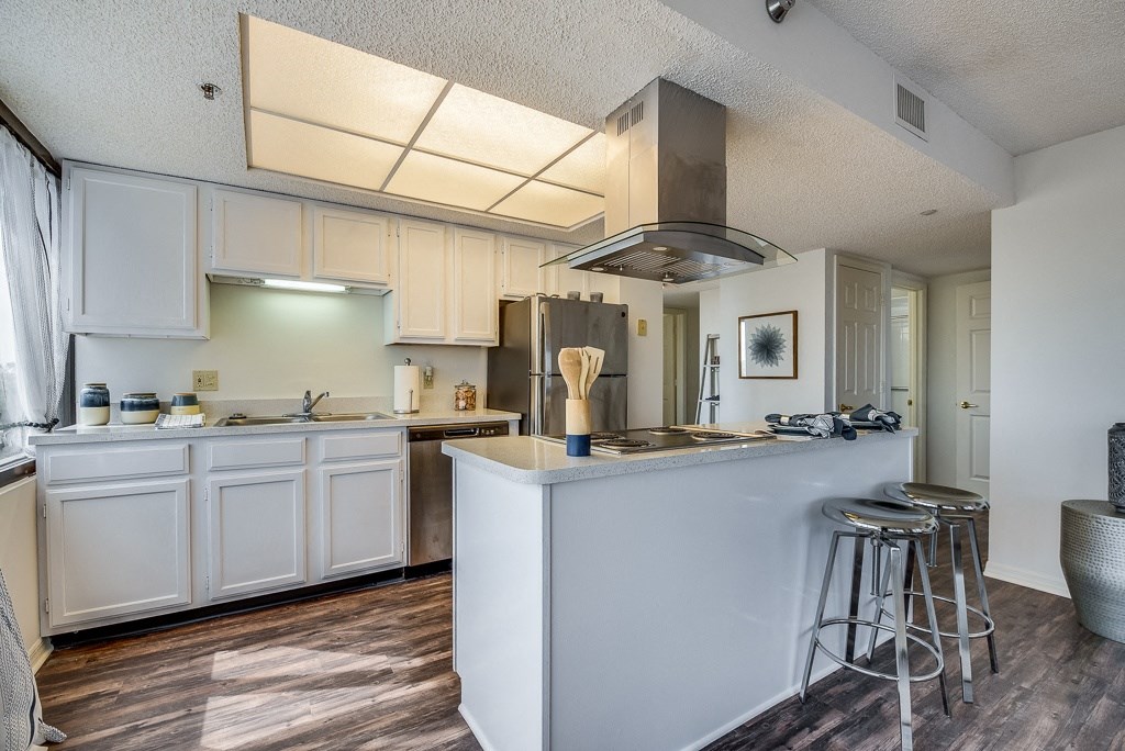 a kitchen with an island and stools
