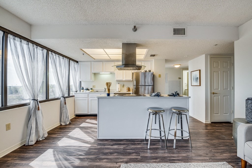 a kitchen with a breakfast bar and stools