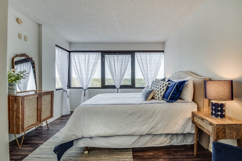 a bedroom with a large bed and a large window
