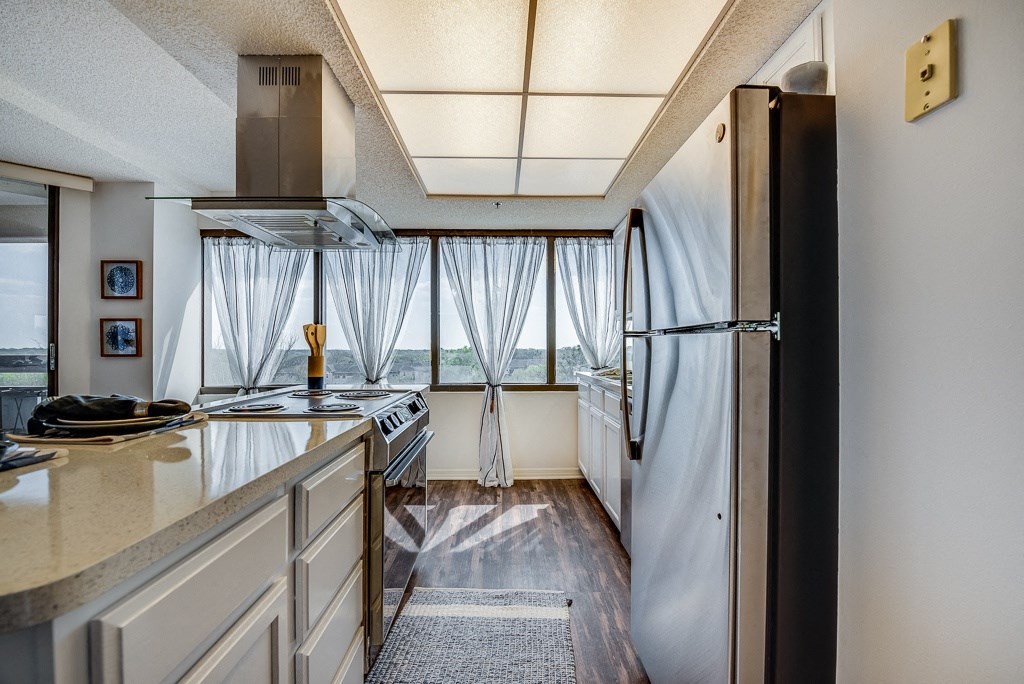 a kitchen with a stove and a refrigerator