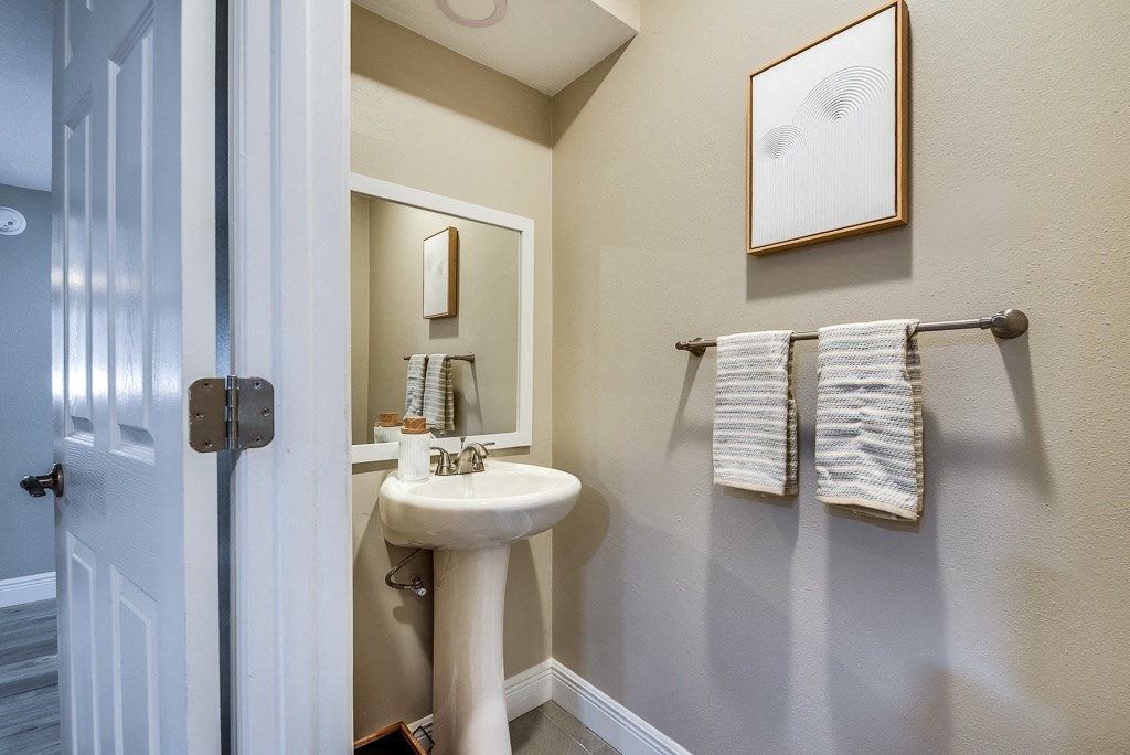 a bathroom with gray walls and a white sink