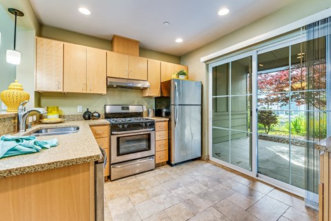 A kitchen with wooden cabinets and a glass door refrigerator.