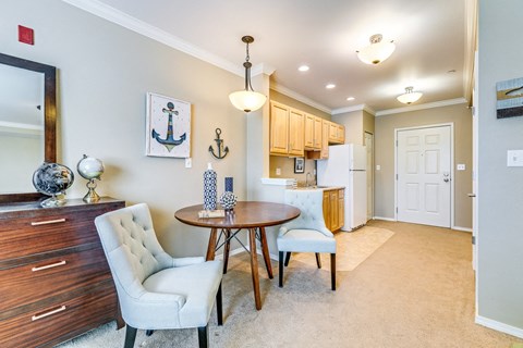 A dining room with a table and chairs.