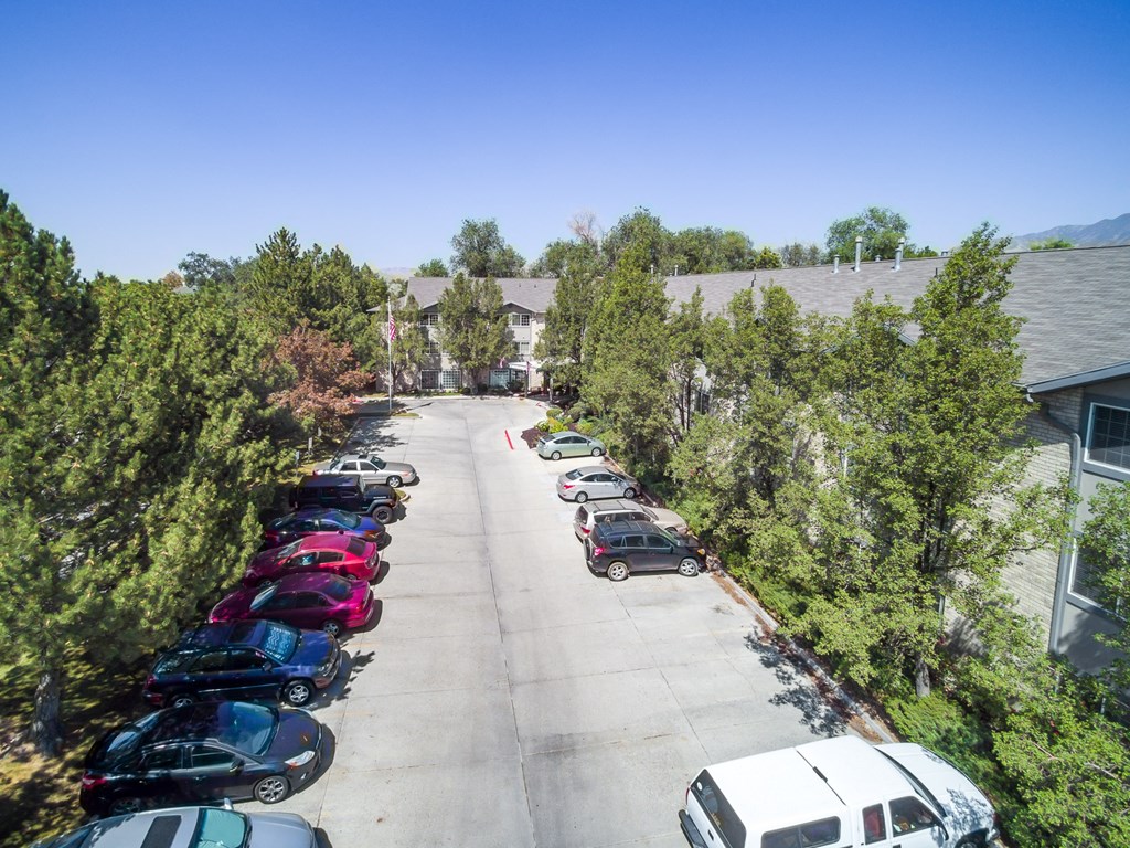 a parking lot with cars in front of a building