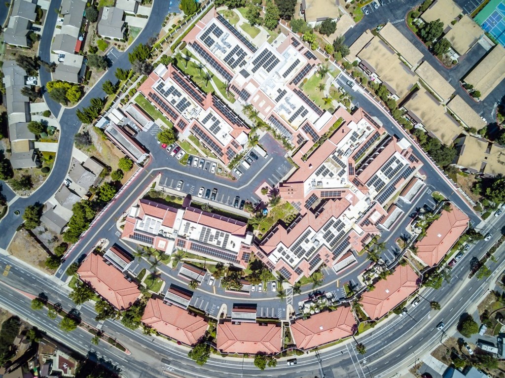 an aerial view of a building surrounded by streets and cars