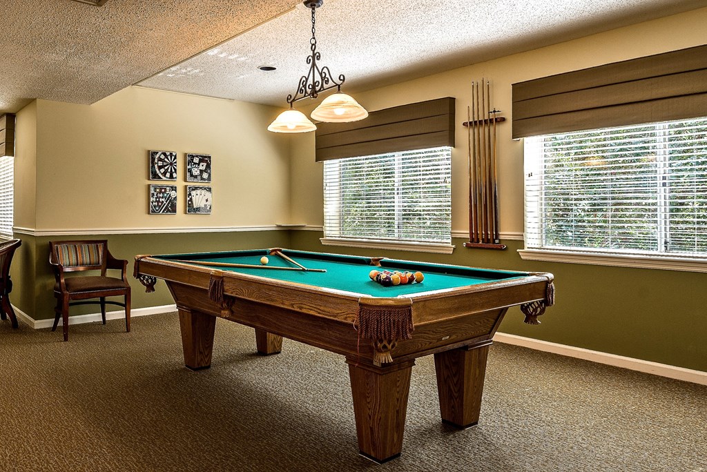 a game room with a pool table