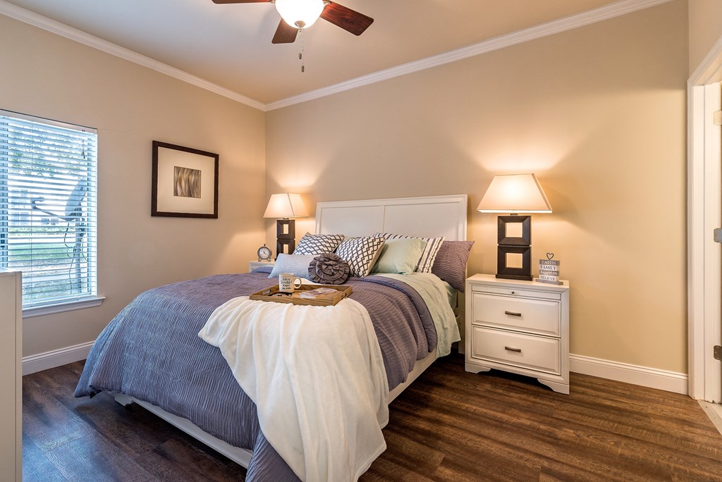 a bedroom with a bed and a ceiling fan