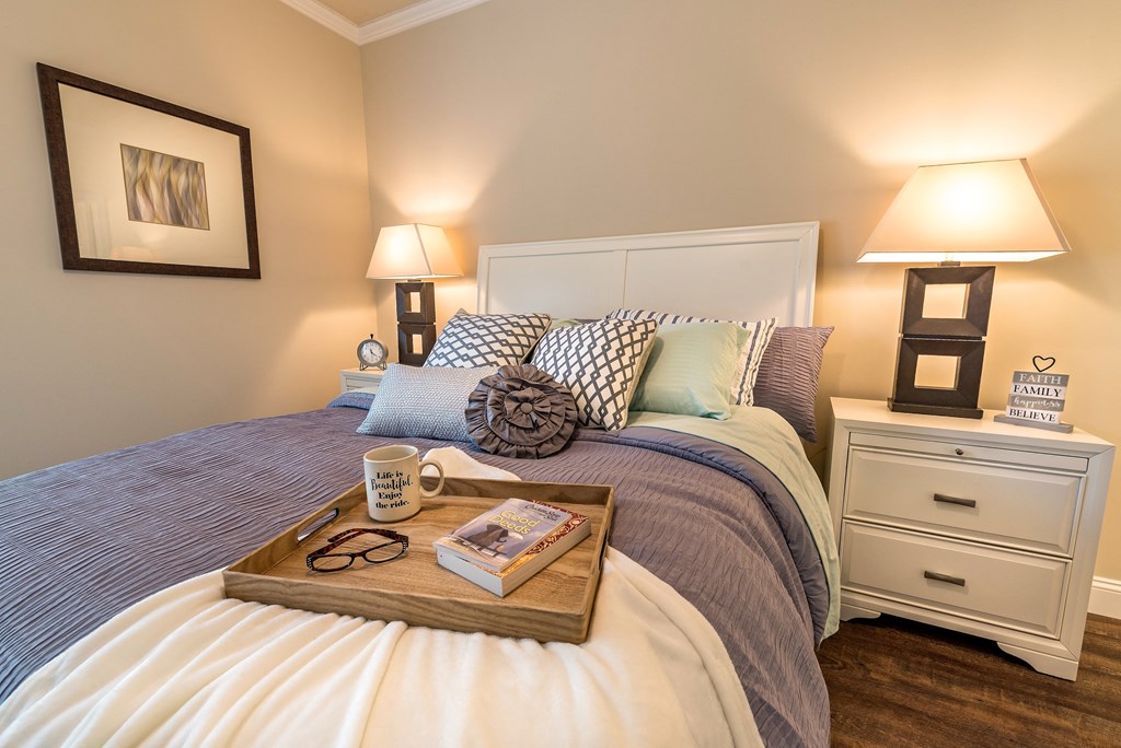 a bedroom with a tray on top of a bed