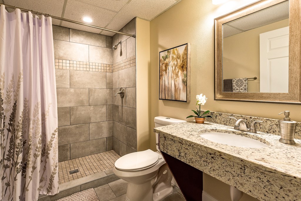 a bathroom with a sink toilet and shower
