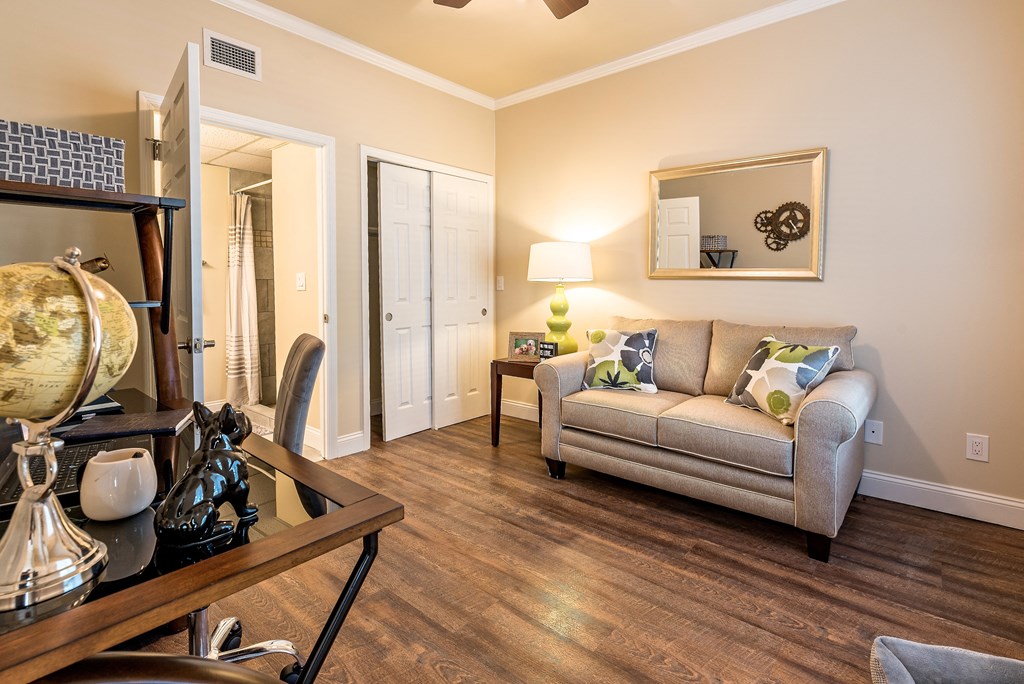 a living room with a couch and a desk