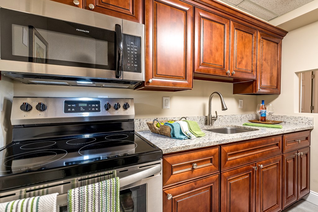 a kitchen with stainless steel appliances and wooden cabinets