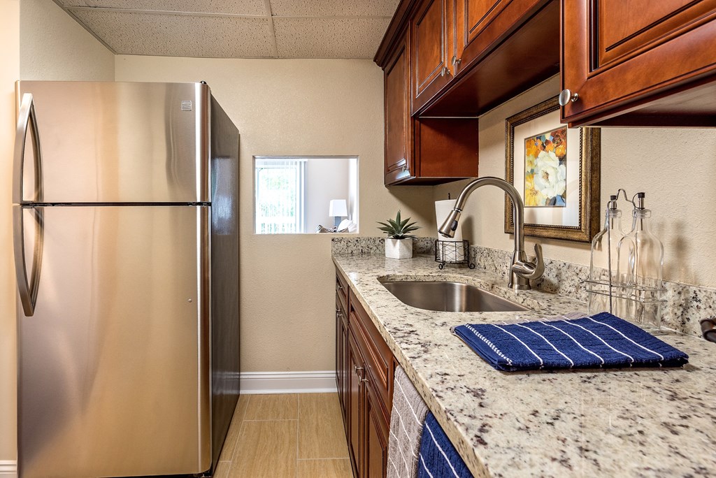 a kitchen with stainless steel appliances and granite counter tops