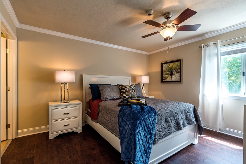 a bedroom with a bed and a ceiling fan