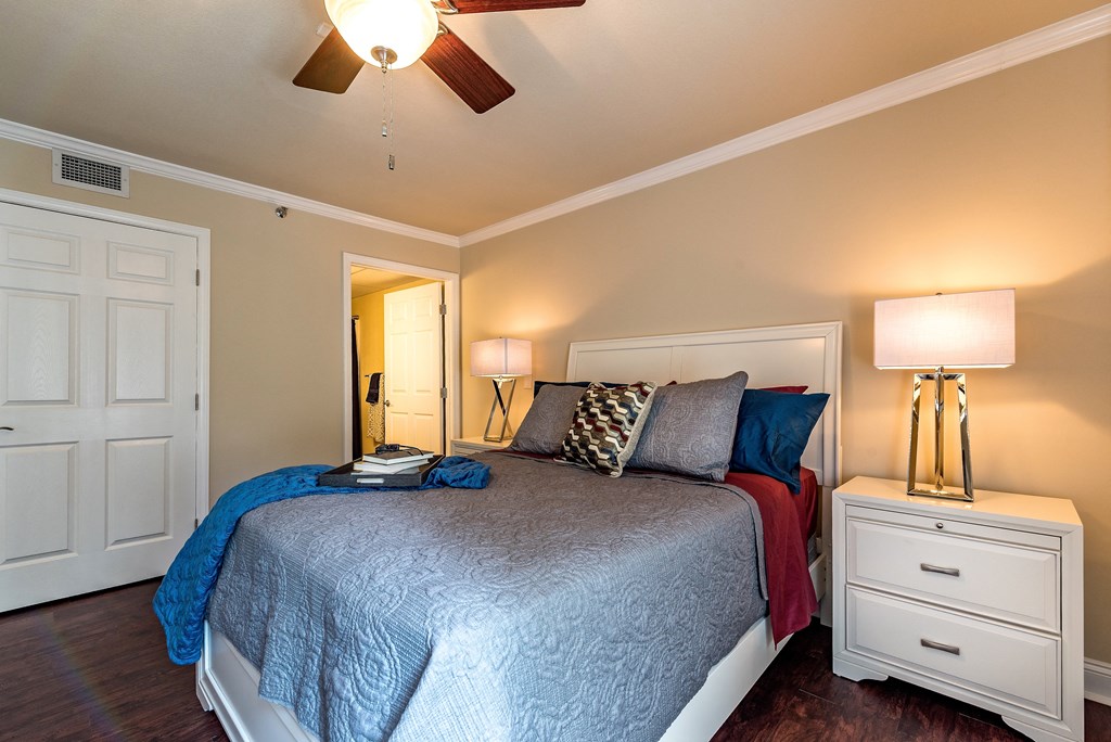 a bedroom with a large bed and a ceiling fan