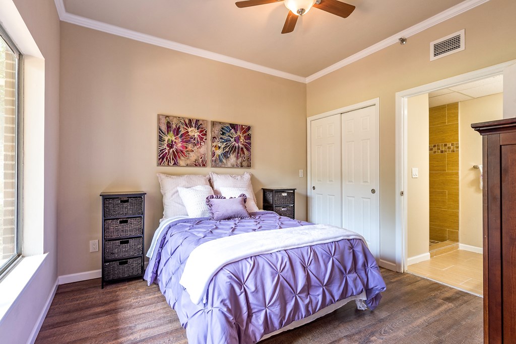 a bedroom with a bed and a ceiling fan