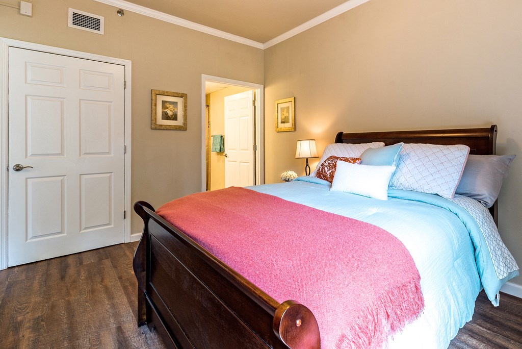 a bedroom with a bed and a door to a bathroom