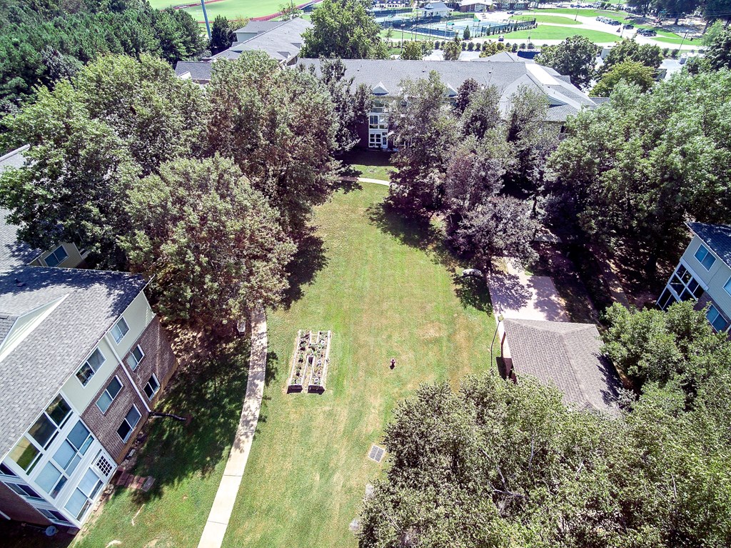 an aerial view of a yard with trees and houses