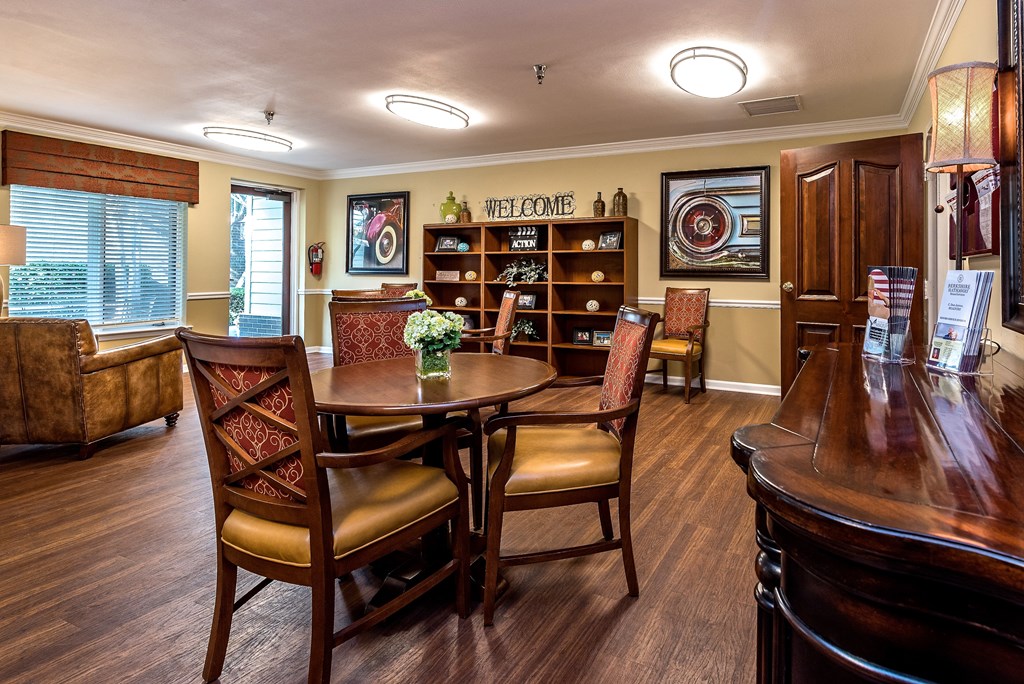 a dining room with a table and chairs and a piano