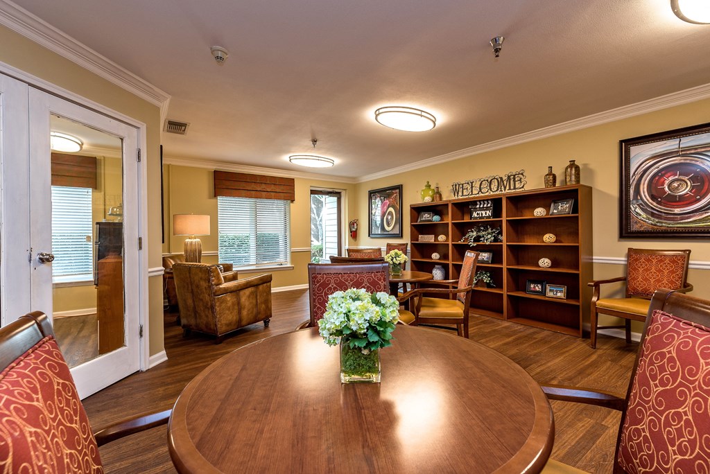 a living room with a wooden table and chairs