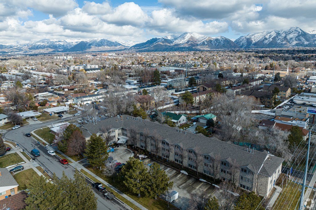 an aerial view of a city with mountains in the background