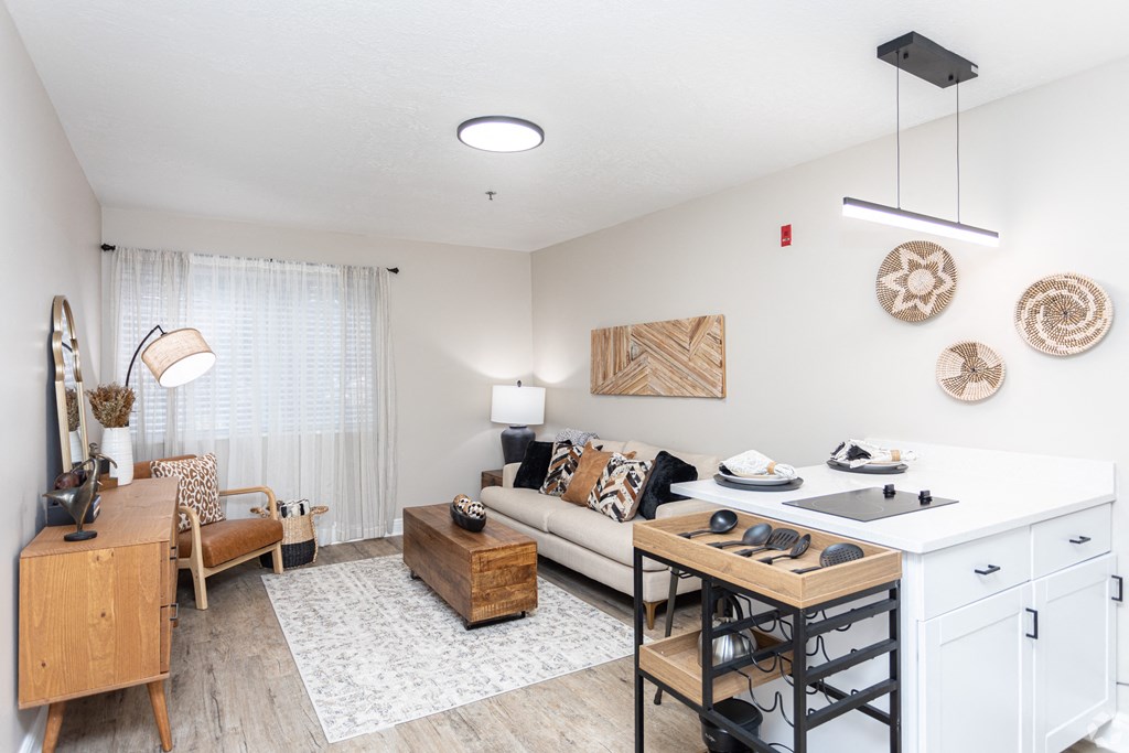 a living room with a kitchen and a dining table