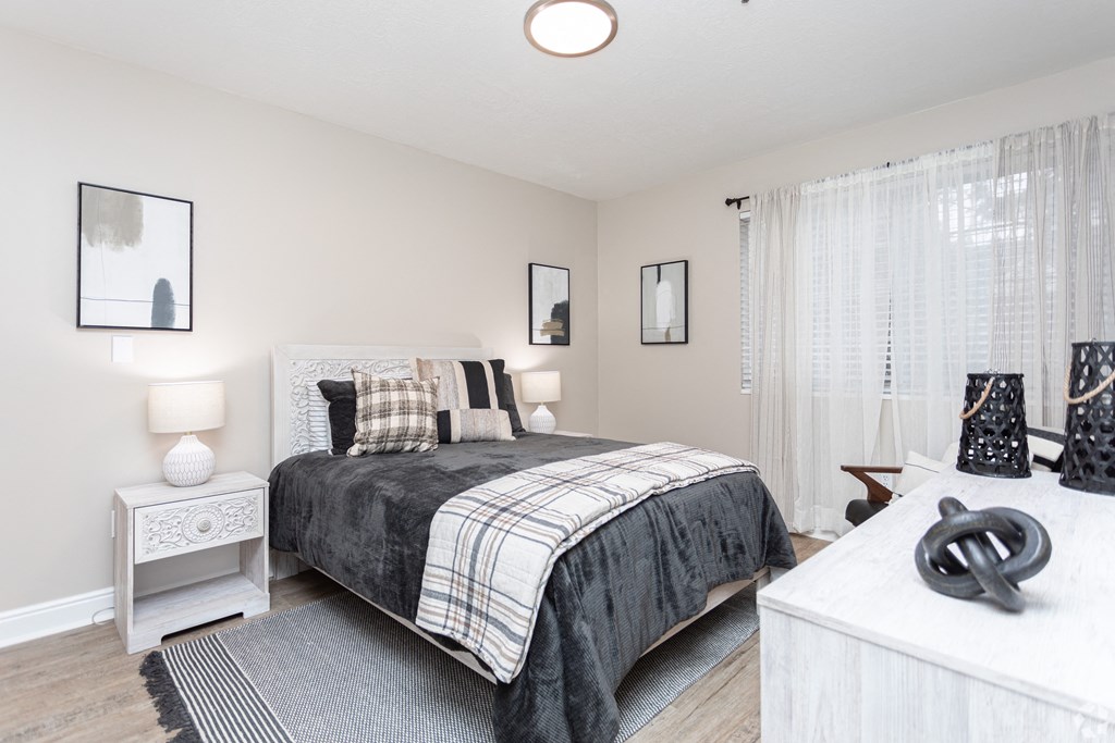 a bedroom with a bed and a white dresser