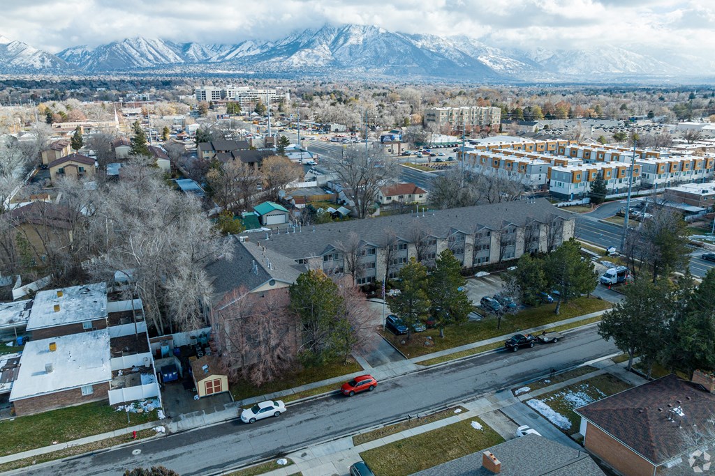 an aerial view of a city with mountains in the background