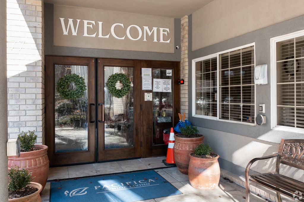 the entrance of a building with doors and a welcome sign