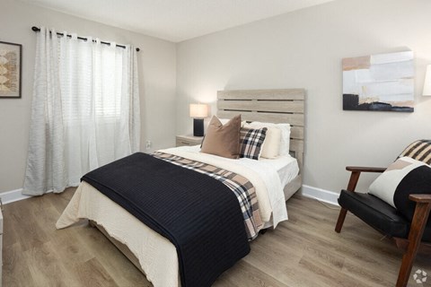 a bedroom with a bed and a chair