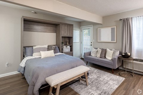 a bedroom with a bed and a couch