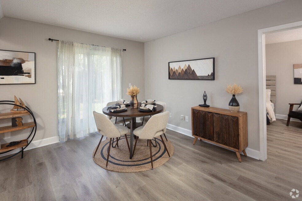 a dining room with a table and chairs