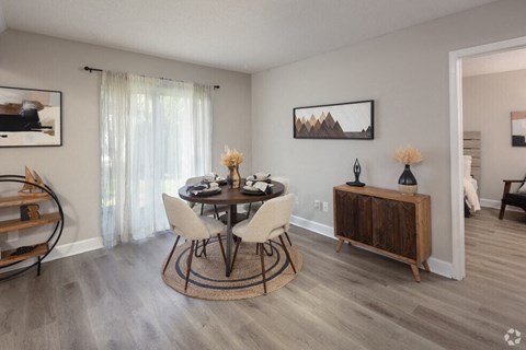 a dining room with a table and chairs