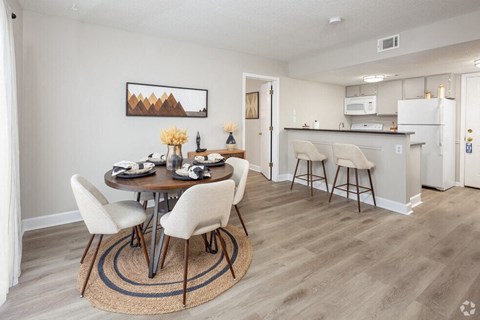 a dining room and kitchen with a table and chairs